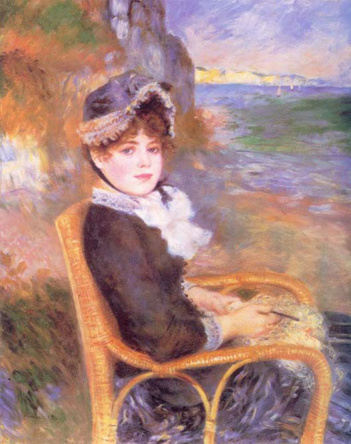 Femme assise au bord de la mer